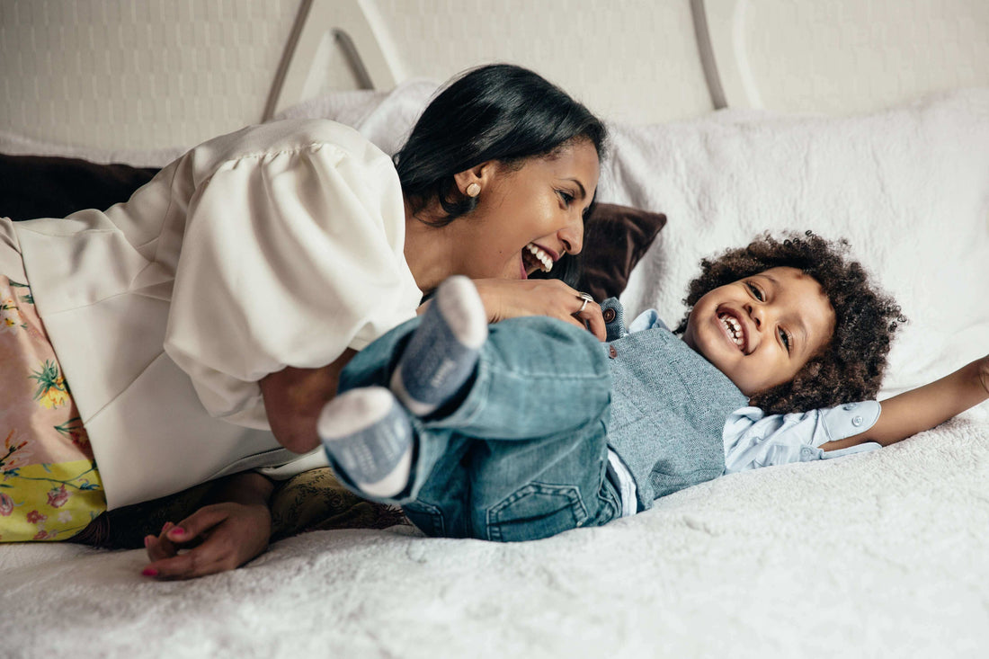 A parent checking a toddler's temperature during a fever