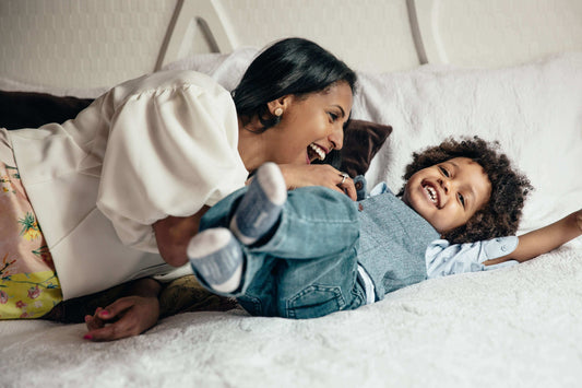 A parent checking a toddler's temperature during a fever