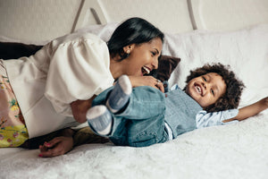 A parent checking a toddler's temperature during a fever